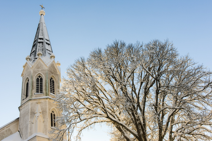 A church steeple against a clear winter sky